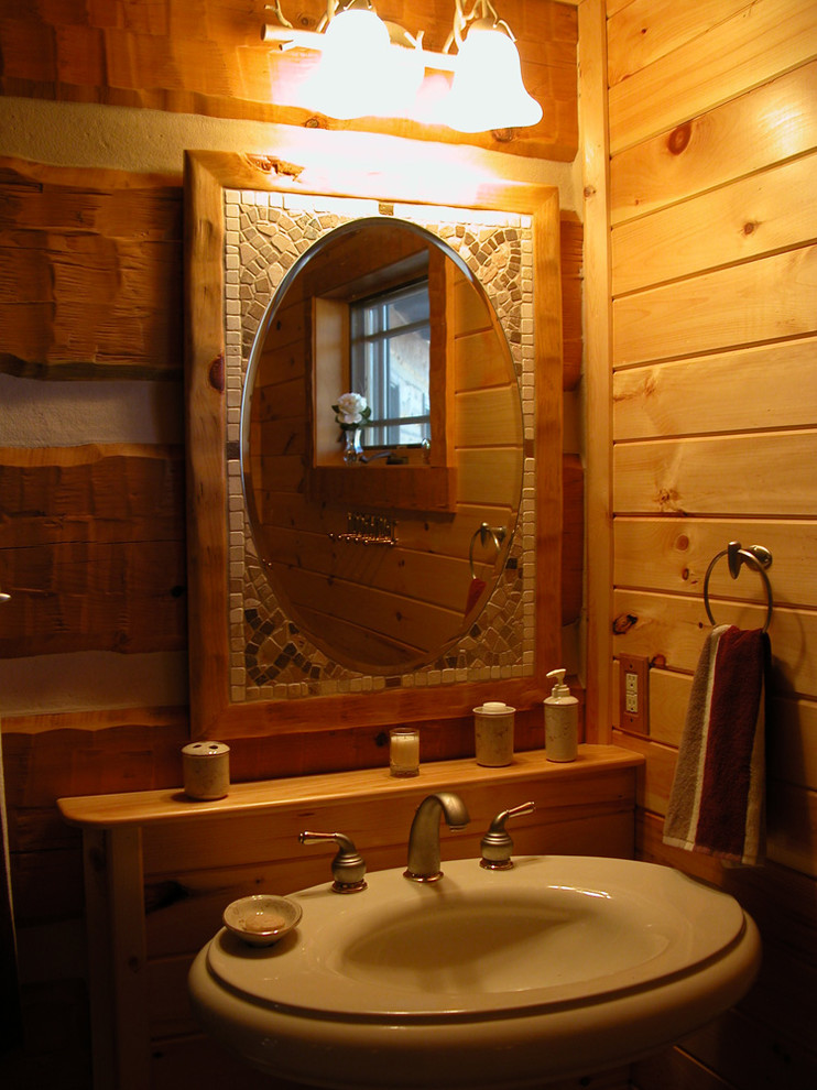 Cette image montre une petite salle de bain rustique en bois foncé avec un lavabo intégré, un placard avec porte à panneau encastré, un plan de toilette en bois, une baignoire posée, WC à poser, un carrelage marron, un carrelage de pierre, un mur beige et un sol en carrelage de céramique.