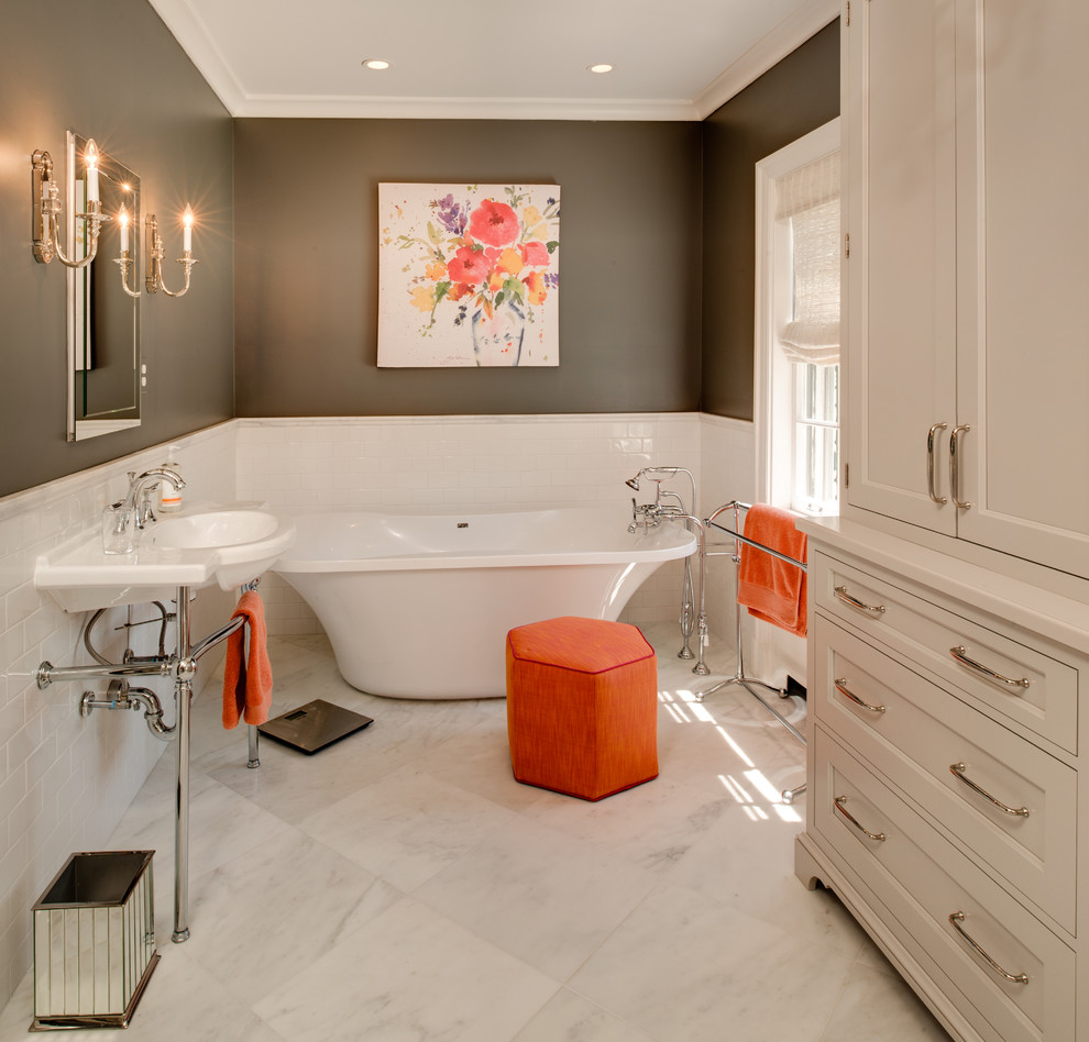 Photo of a classic bathroom in Detroit with shaker cabinets, a freestanding bath, metro tiles, grey walls, a wall-mounted sink and white floors.