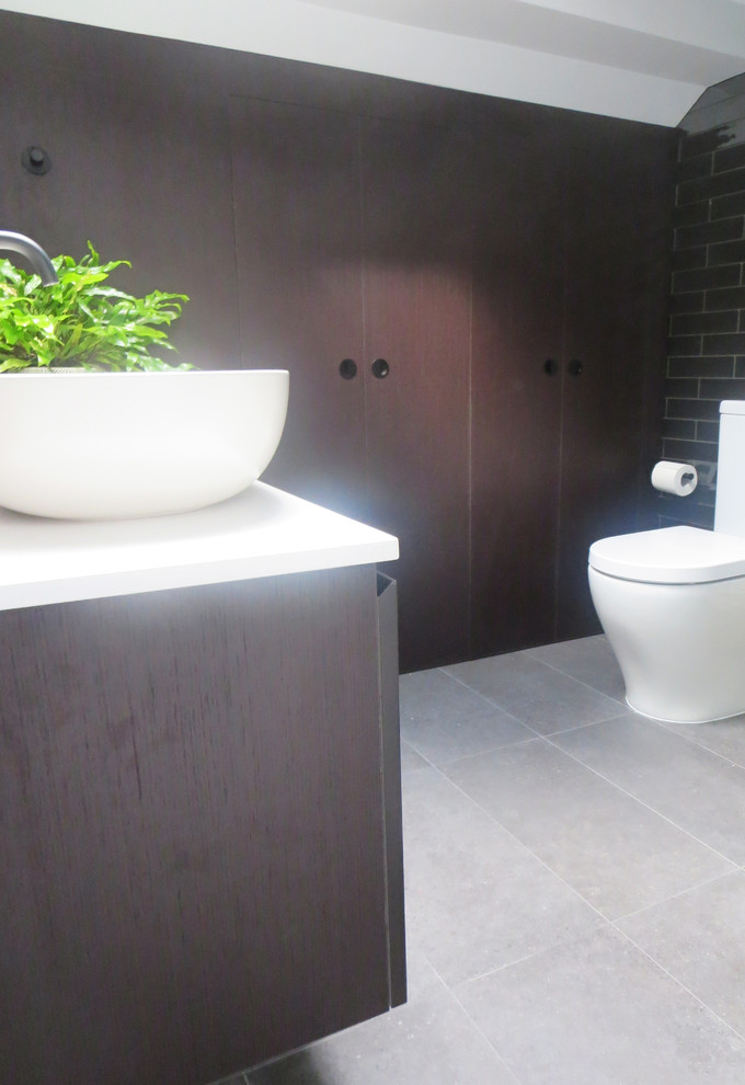 Small trendy bathroom photo in Sydney with furniture-like cabinets and dark wood cabinets