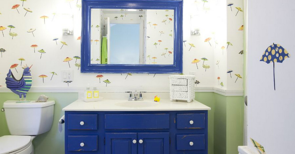 Bathroom - large coastal 3/4 bathroom idea in Boston with raised-panel cabinets, blue cabinets, a two-piece toilet, multicolored walls, an integrated sink and laminate countertops