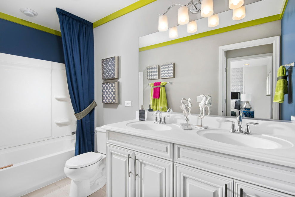 Photo of a medium sized eclectic bathroom in Chicago with raised-panel cabinets, white cabinets, an alcove bath, a shower/bath combination, a two-piece toilet, white walls, porcelain flooring, an integrated sink, solid surface worktops and a shower curtain.