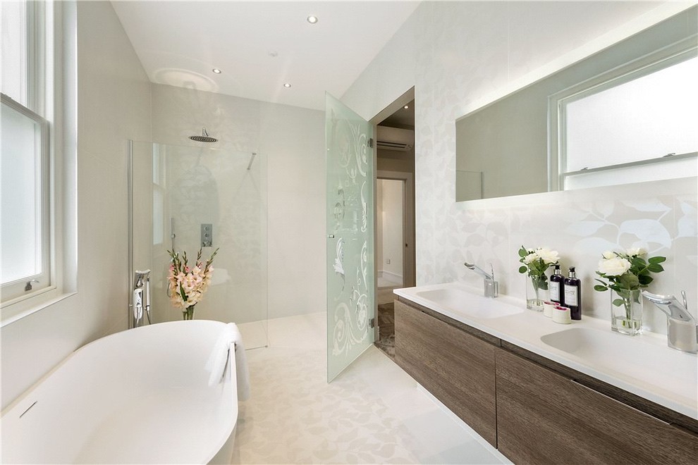 Design ideas for a medium sized contemporary ensuite bathroom in Oxfordshire with medium wood cabinets, a freestanding bath, a walk-in shower, a wall mounted toilet, white tiles, porcelain tiles, white walls, porcelain flooring and a wall-mounted sink.
