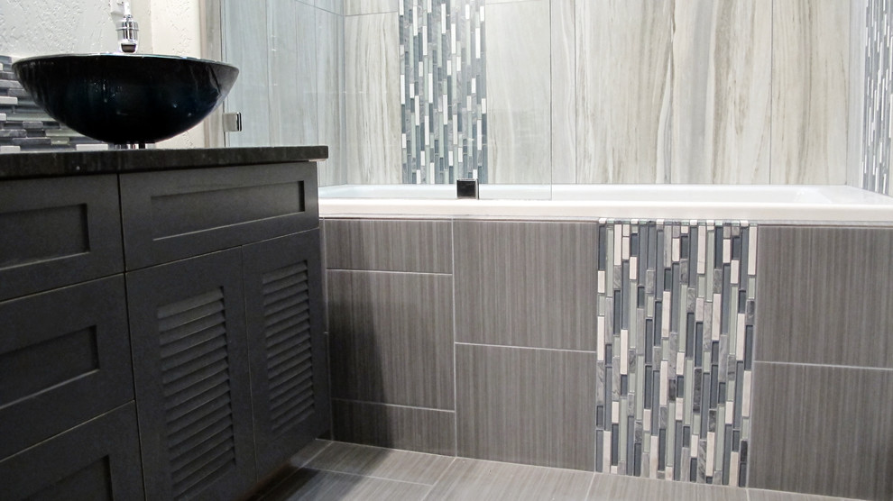 Example of a mid-sized trendy kids' gray tile and porcelain tile ceramic tile bathroom design in Seattle with a vessel sink, louvered cabinets, gray cabinets, granite countertops and beige walls