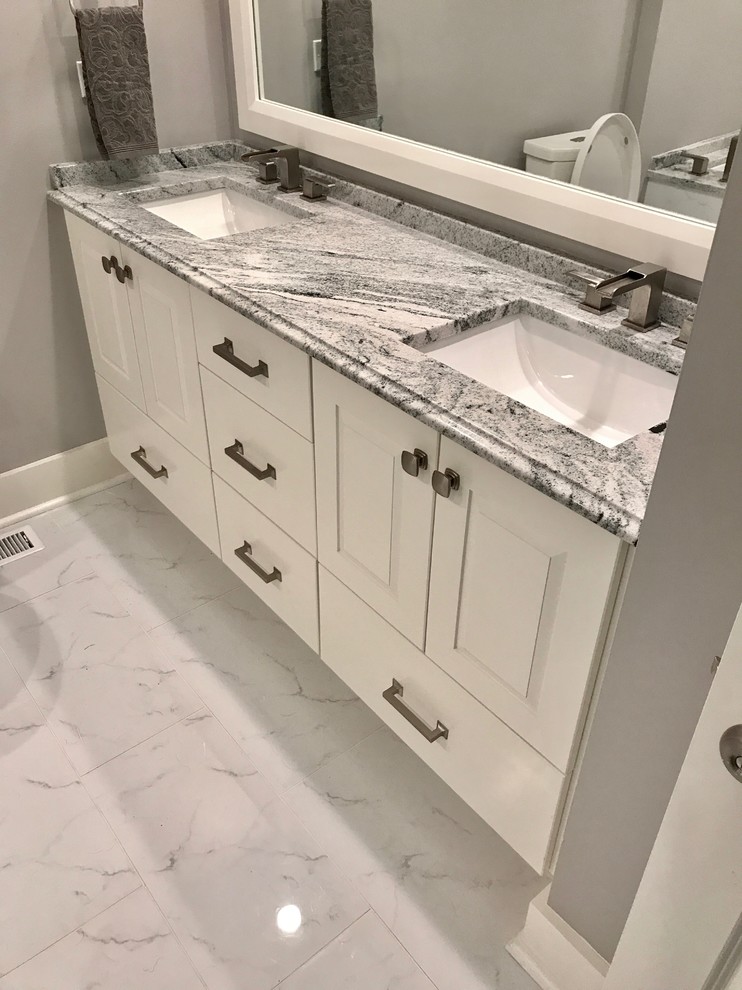 Large traditional ensuite bathroom in Chicago with shaker cabinets, white cabinets, an alcove shower, a two-piece toilet, grey tiles, white tiles, stone tiles, grey walls, marble flooring, a submerged sink, granite worktops, multi-coloured floors and a hinged door.
