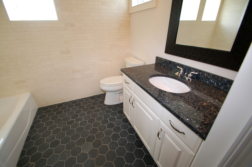 Small elegant 3/4 porcelain tile bathroom photo in New York with an undermount sink, raised-panel cabinets, white cabinets, granite countertops and white walls