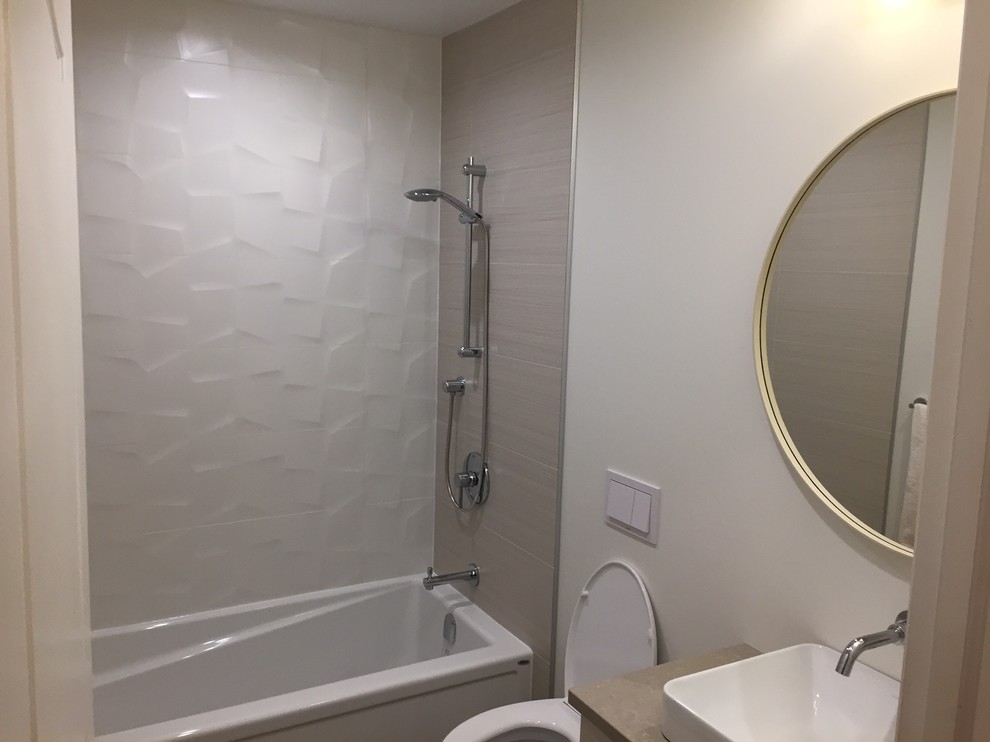 Design ideas for a small modern shower room bathroom in Edmonton with flat-panel cabinets, white cabinets, an alcove bath, a shower/bath combination, a wall mounted toilet, white tiles, porcelain tiles, white walls, lino flooring, a submerged sink, engineered stone worktops, grey floors and a shower curtain.