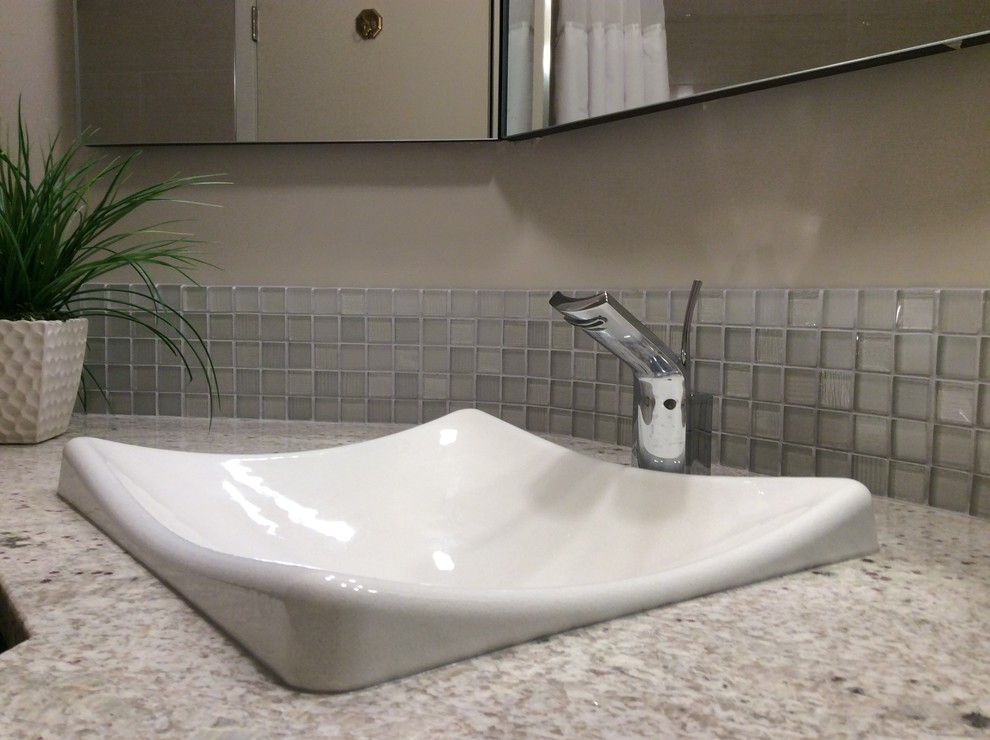 Photo of a small classic ensuite bathroom in Edmonton with flat-panel cabinets, dark wood cabinets, an alcove bath, a shower/bath combination, a one-piece toilet, white tiles, porcelain tiles, beige walls, porcelain flooring, a built-in sink, granite worktops, grey floors and a shower curtain.
