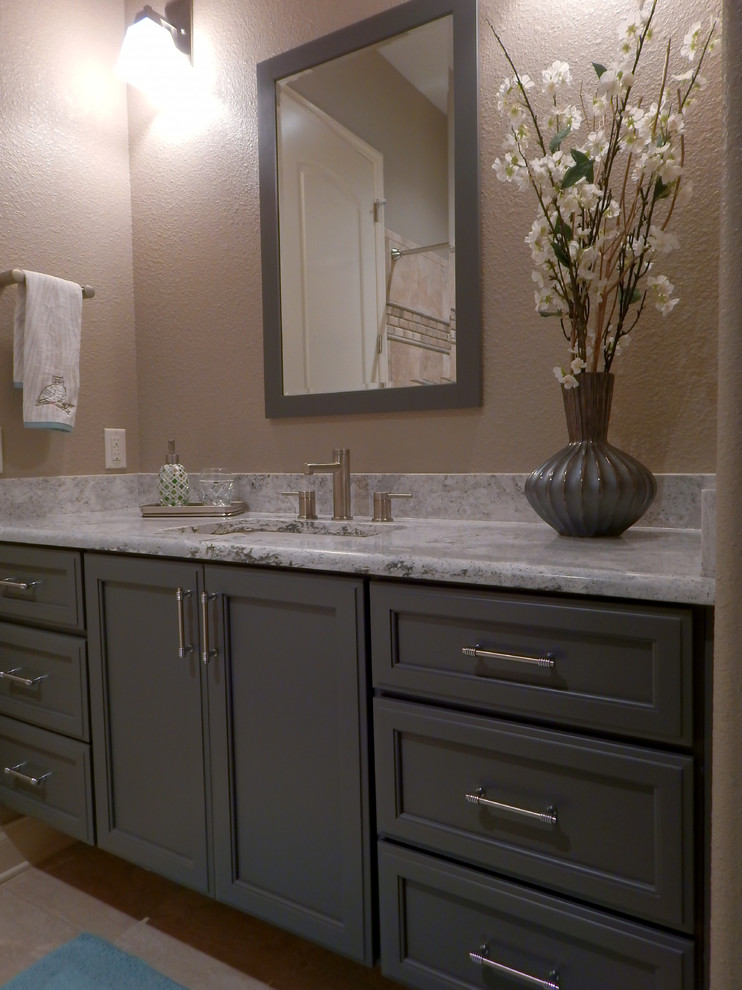 This is an example of a contemporary bathroom in Tampa with a submerged sink, grey cabinets, engineered stone worktops, beige tiles, porcelain tiles, beige walls and porcelain flooring.
