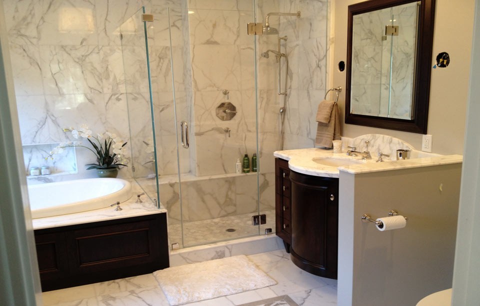 Bathroom - mid-sized traditional master gray tile, white tile and stone tile marble floor and white floor bathroom idea in San Francisco with raised-panel cabinets, dark wood cabinets, a one-piece toilet, beige walls, an undermount sink, marble countertops and a hinged shower door