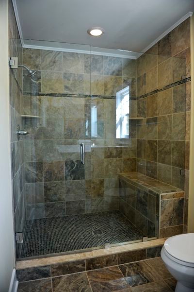 Inspiration for a mid-sized timeless brown tile pebble tile floor bathroom remodel in Other