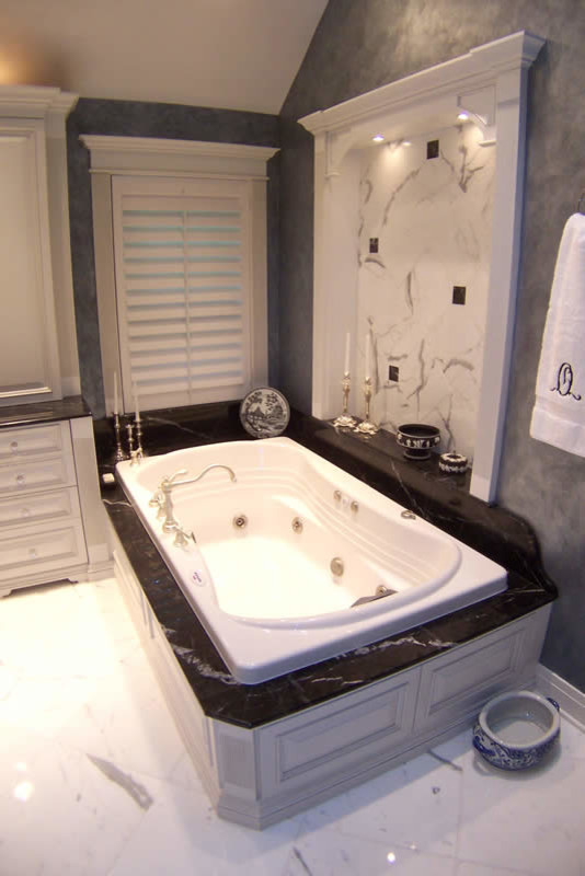 Inspiration for a large timeless master marble floor drop-in bathtub remodel in Chicago with raised-panel cabinets, white cabinets, gray walls, a drop-in sink and granite countertops