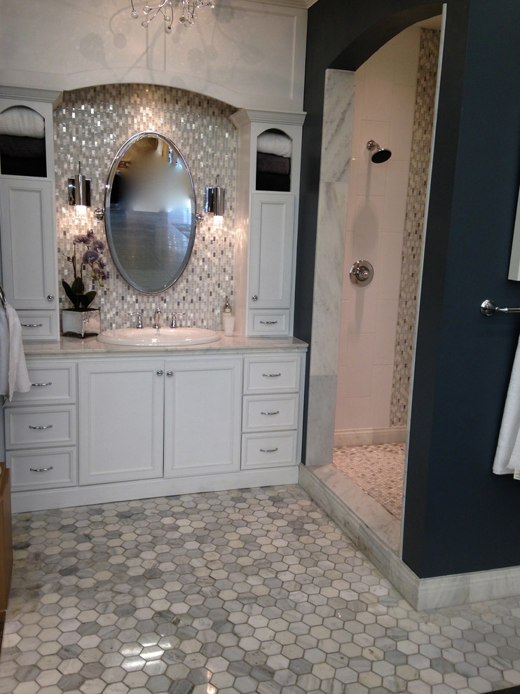 Пример оригинального дизайна: ванная комната среднего размера в классическом стиле с фасадами с утопленной филенкой, белыми фасадами, синими стенами, полом из керамогранита, накладной раковиной и мраморной столешницей