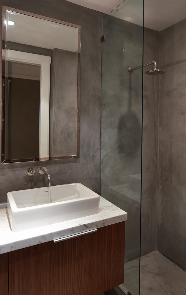 Foto de cuarto de baño principal asiático pequeño con lavabo bajoencimera, armarios tipo mueble, puertas de armario de madera oscura, encimera de mármol, ducha esquinera y paredes grises