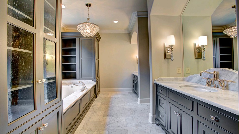 Inspiration for a large timeless master white tile and stone tile marble floor bathroom remodel in Other with an undermount sink, gray cabinets, marble countertops, an undermount tub, gray walls and shaker cabinets