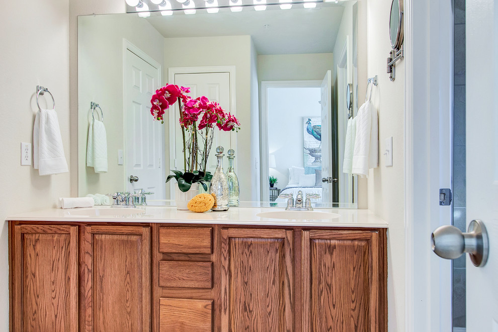 Elegant bathroom photo in Dallas with medium tone wood cabinets