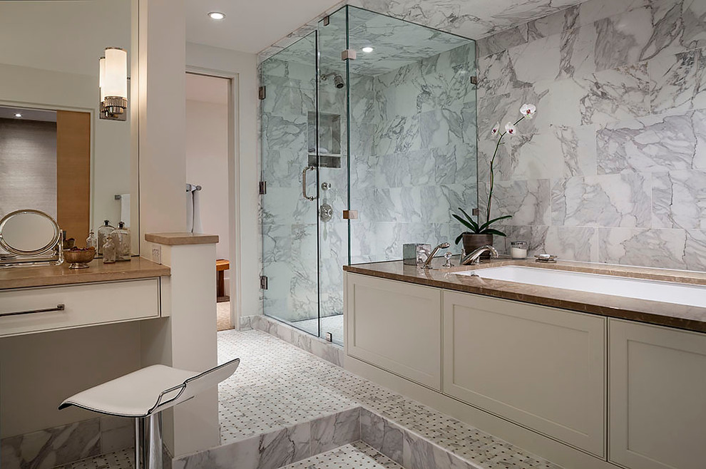 Design ideas for a large classic ensuite bathroom in Minneapolis with a submerged sink, flat-panel cabinets, white cabinets, a submerged bath, a corner shower, a two-piece toilet, white tiles, stone slabs, white walls, ceramic flooring, engineered stone worktops and white floors.