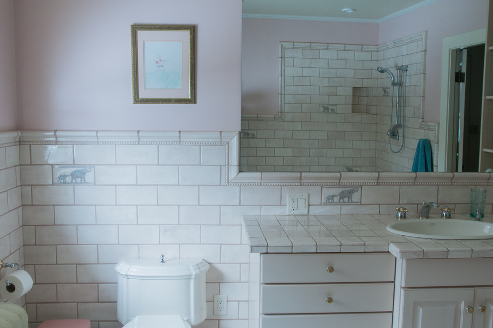 Bathroom - contemporary master ceramic tile and white tile ceramic tile bathroom idea in Other with raised-panel cabinets, white cabinets, pink walls, a drop-in sink and tile countertops