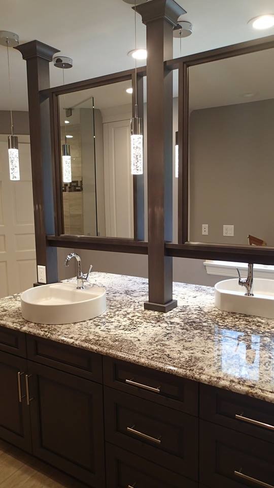 Modern inredning av ett en-suite badrum, med ett fristående handfat, granitbänkskiva, en kantlös dusch, porslinskakel och klinkergolv i porslin