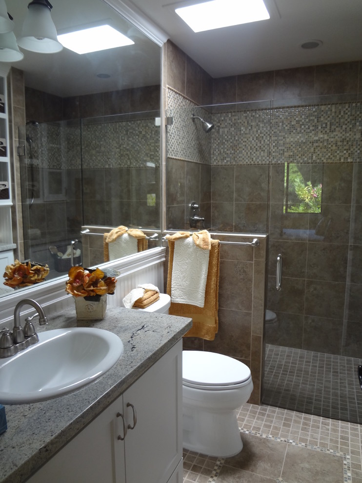 Example of a mid-sized transitional 3/4 beige tile and mosaic tile ceramic tile and beige floor walk-in shower design in San Francisco with recessed-panel cabinets, white cabinets, a two-piece toilet, beige walls, a drop-in sink, quartz countertops and a hinged shower door