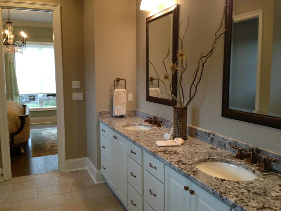 Example of a transitional bathroom design in New Orleans with an undermount sink and granite countertops