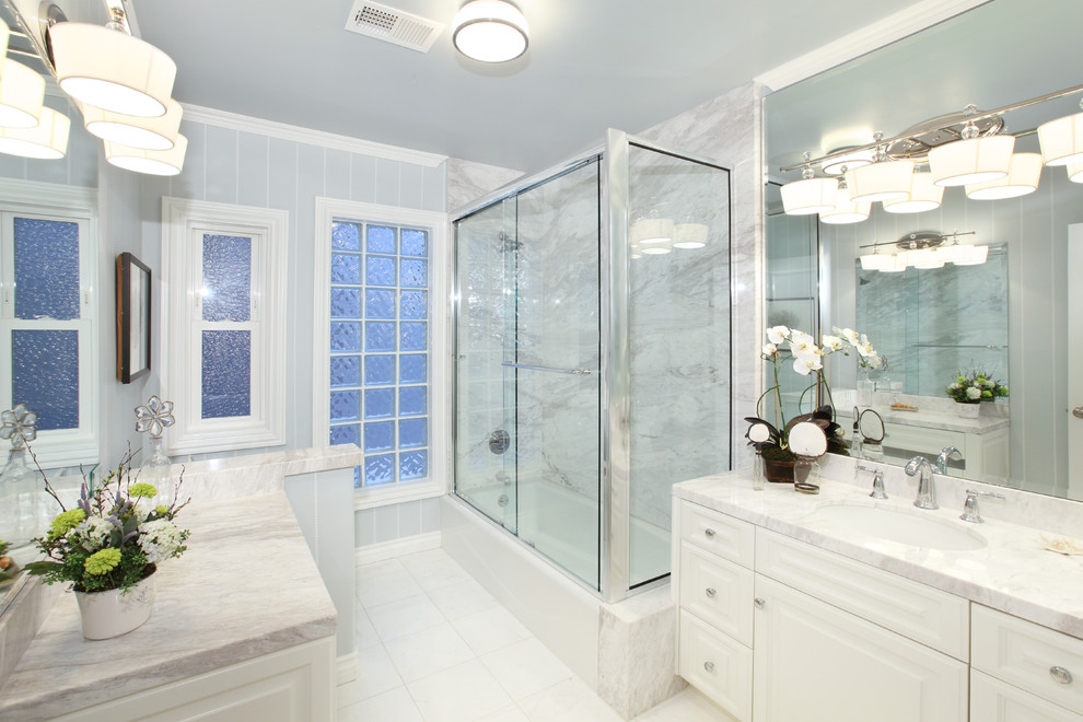 Bathroom in Orange County with white cabinets, a corner shower, white tiles, grey worktops and feature lighting.