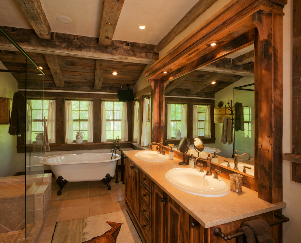 Idee per una grande stanza da bagno padronale rustica con ante lisce, ante in legno scuro, vasca con piedi a zampa di leone e piastrelle beige
