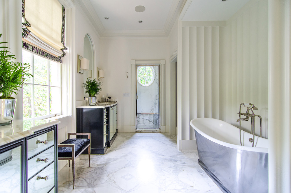 Freestanding bathtub - white tile freestanding bathtub idea in Atlanta with an undermount sink and flat-panel cabinets