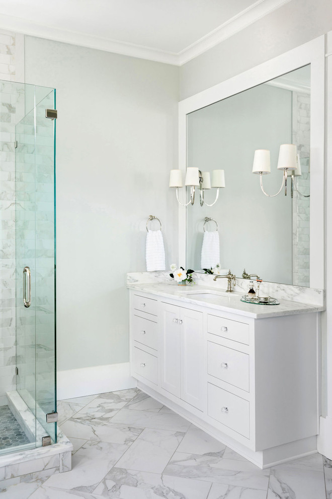 Example of a large master white tile and marble tile marble floor and white floor bathroom design in Atlanta with recessed-panel cabinets, white cabinets, a two-piece toilet, gray walls, an undermount sink, marble countertops, a hinged shower door and white countertops