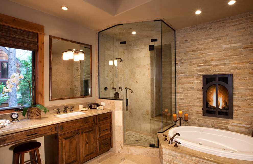 Cette image montre une grande salle de bain principale traditionnelle en bois foncé avec un placard avec porte à panneau surélevé, une baignoire posée, une douche d'angle, un carrelage beige, un carrelage marron, un carrelage gris, un carrelage de pierre, un mur marron, un sol en carrelage de porcelaine, un lavabo encastré, un plan de toilette en granite, un sol beige, une cabine de douche à porte battante et un plan de toilette multicolore.