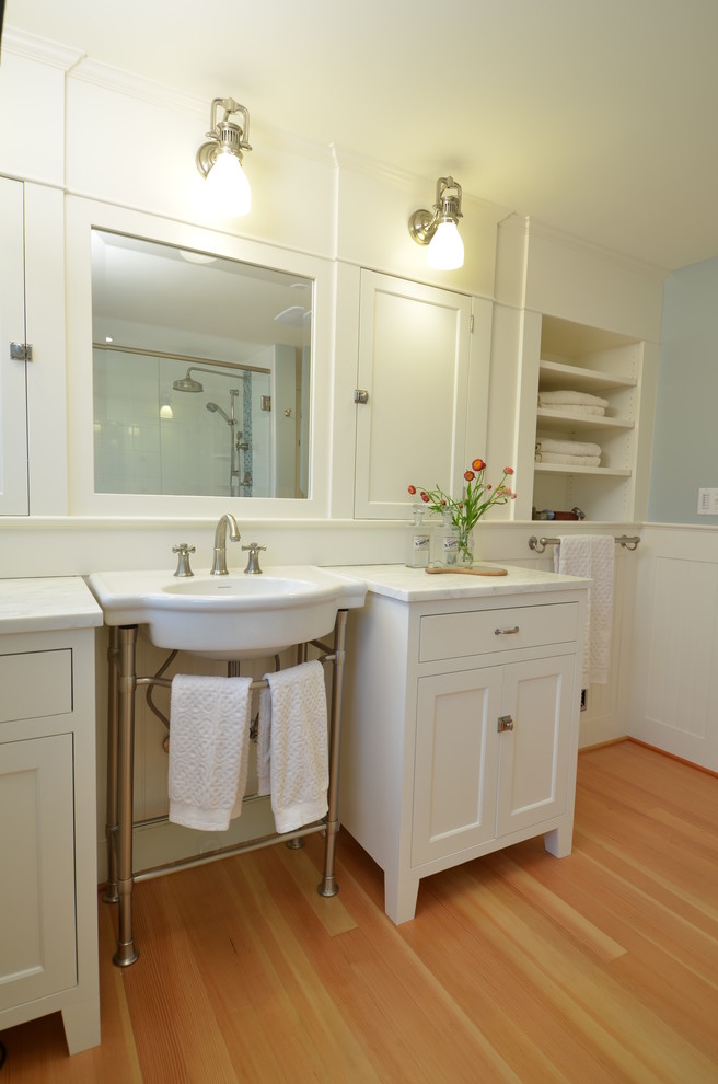 Idéer för att renovera ett mellanstort amerikanskt badrum, med skåp i shakerstil, vita skåp, marmorbänkskiva, blå väggar, ljust trägolv och ett konsol handfat