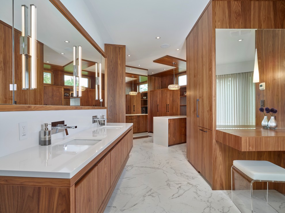 Пример оригинального дизайна: большая главная ванная комната в современном стиле с врезной раковиной, плоскими фасадами, фасадами цвета дерева среднего тона, столешницей из искусственного кварца, белой плиткой, белыми стенами и мраморным полом