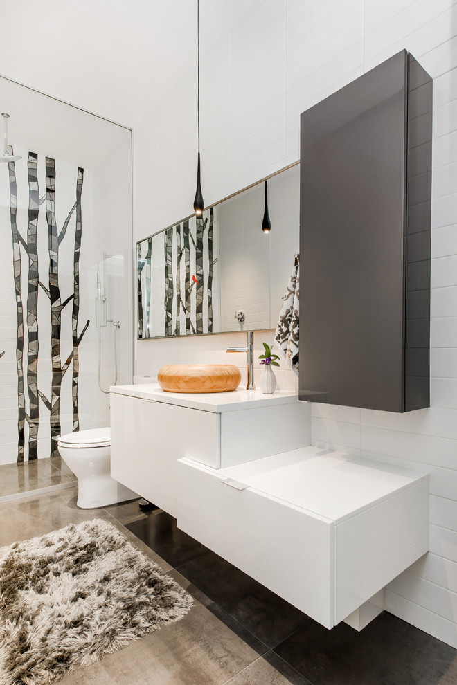 This is an example of a large contemporary bathroom in Calgary with flat-panel cabinets, white cabinets, white tiles, white walls, ceramic flooring, a vessel sink and engineered stone worktops.