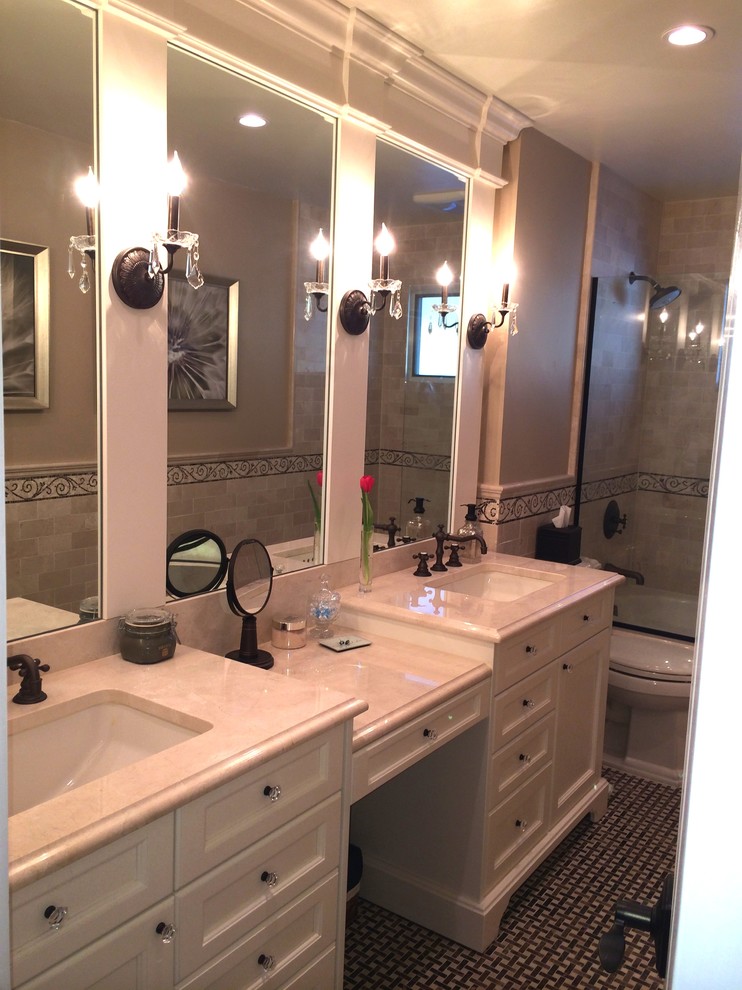 Small elegant master beige tile and stone tile marble floor bathroom photo in New York with a drop-in sink, recessed-panel cabinets, white cabinets, marble countertops, a two-piece toilet and beige walls