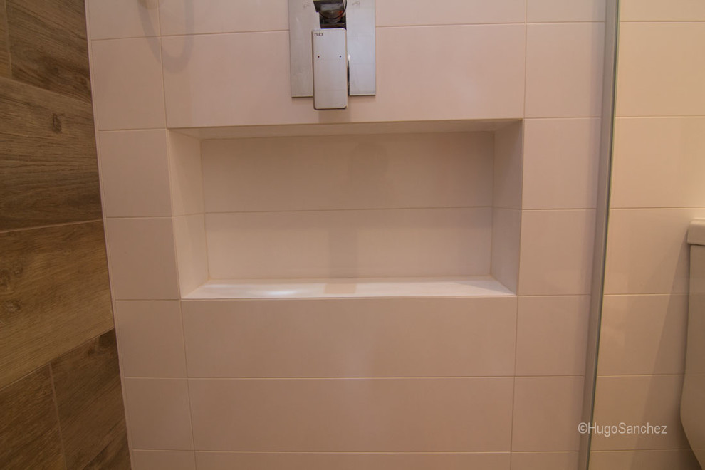 Example of a small trendy kids' porcelain tile walk-in shower design in Montreal with an integrated sink, flat-panel cabinets, light wood cabinets, a one-piece toilet and white walls