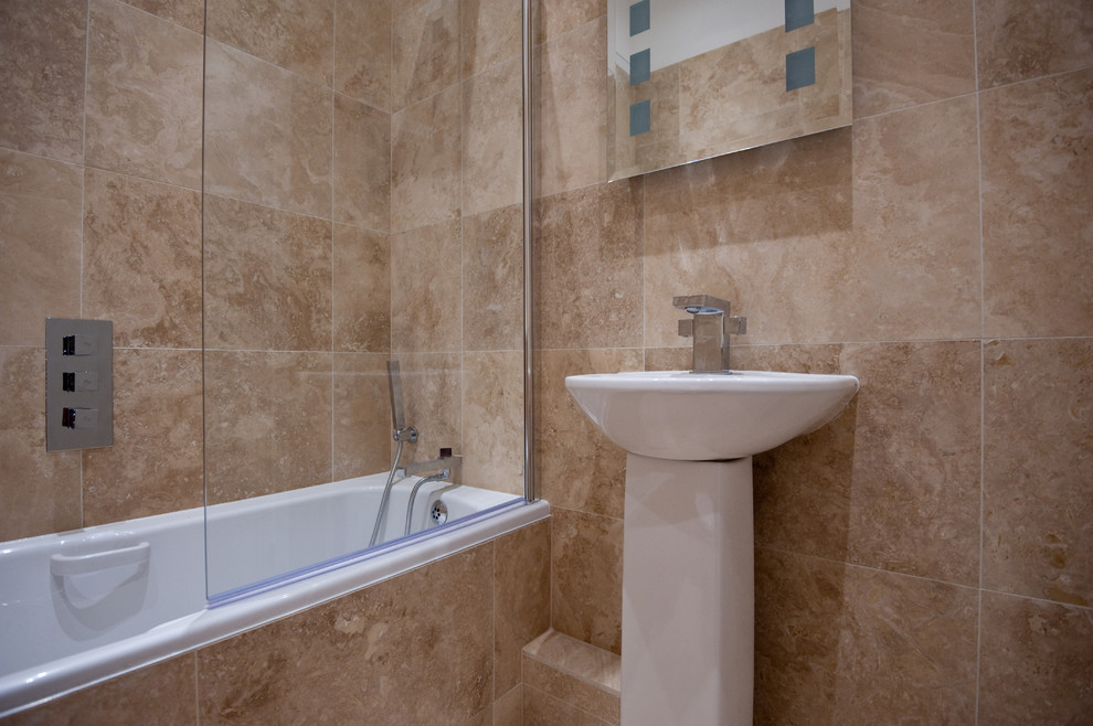 Example of a small trendy master beige tile and ceramic tile ceramic tile bathroom design in London with a pedestal sink, granite countertops, a one-piece toilet and beige walls