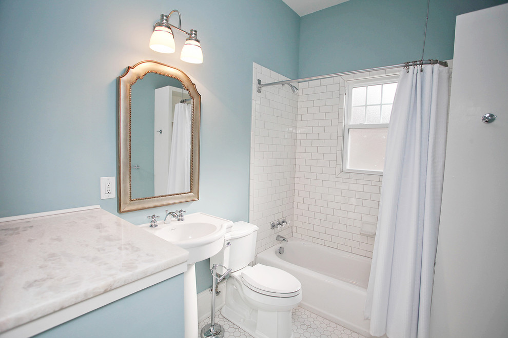 Example of a classic white tile and subway tile bathroom design in Charlotte with a pedestal sink and blue walls