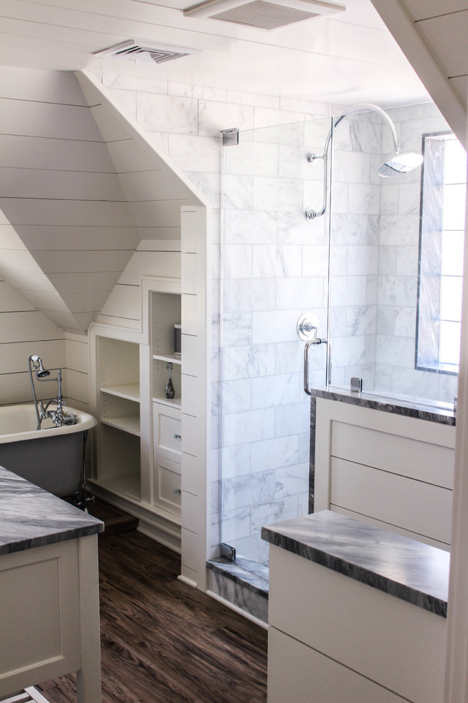 Photo of a small country ensuite bathroom in New York with an integrated sink, freestanding cabinets, white cabinets, marble worktops, an alcove shower, a one-piece toilet, grey tiles, stone slabs, white walls and dark hardwood flooring.