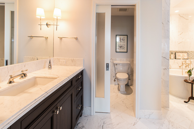 Inspiration for a large transitional master gray tile, white tile and marble tile marble floor and white floor bathroom remodel in Houston with beaded inset cabinets, dark wood cabinets, white walls, an undermount sink, marble countertops and a hinged shower door