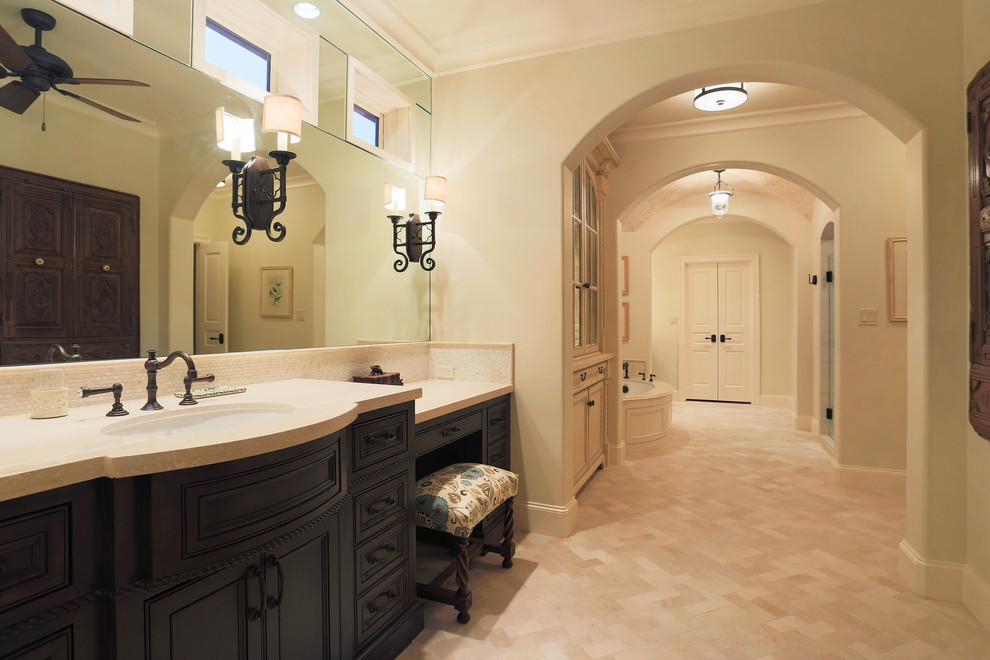 Huge elegant master beige tile bathroom photo in Houston with dark wood cabinets and beige walls