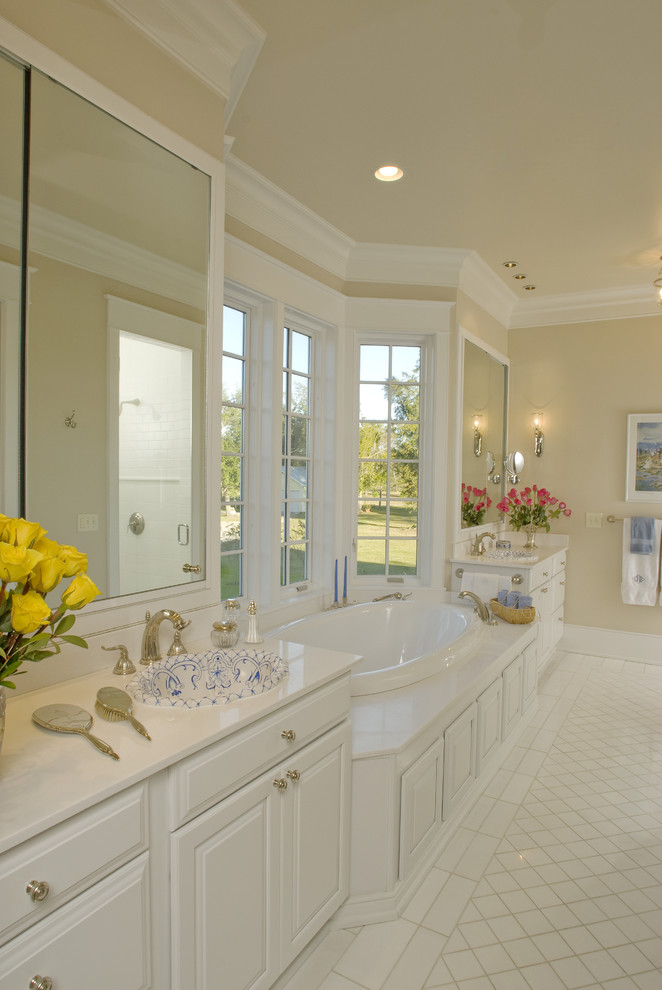 Inspiration for a timeless white tile drop-in bathtub remodel in New Orleans with a drop-in sink, raised-panel cabinets and white cabinets