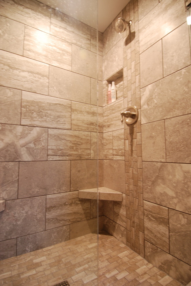 Inspiration for a transitional master gray tile and porcelain tile porcelain tile alcove shower remodel in Milwaukee with an undermount sink, flat-panel cabinets, gray cabinets, solid surface countertops and a two-piece toilet