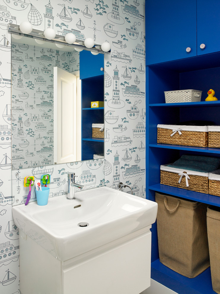 Trendy kids' bathroom photo in London with a console sink