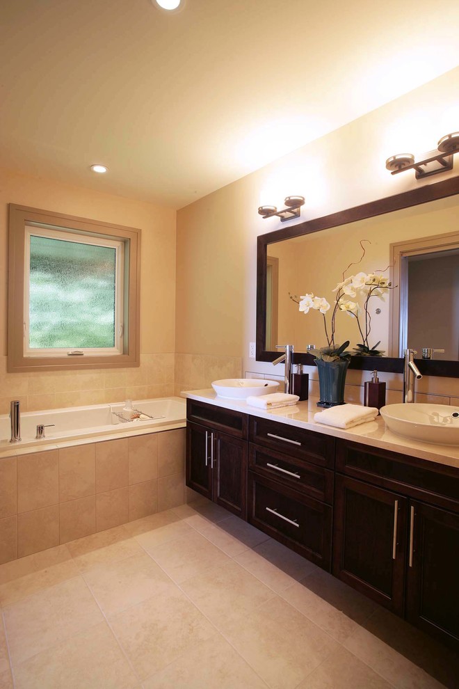 Example of a minimalist beige tile and porcelain tile bathroom design in Vancouver with a vessel sink, shaker cabinets, dark wood cabinets, quartz countertops and a two-piece toilet