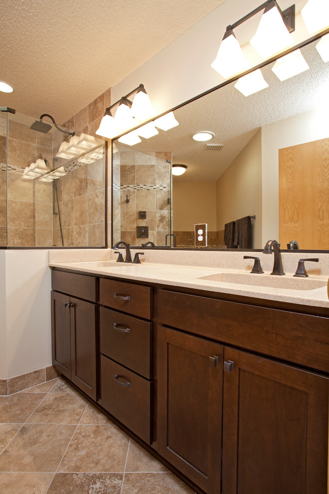 Inspiration for a mid-sized transitional 3/4 beige tile and stone tile travertine floor corner shower remodel in Minneapolis with an integrated sink, shaker cabinets, dark wood cabinets, a two-piece toilet and white walls