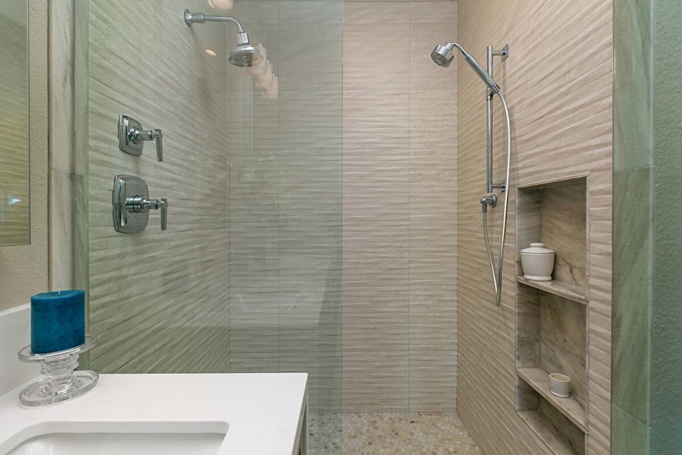 Inspiration for a mid-sized transitional master beige tile and stone tile ceramic tile and beige floor bathroom remodel in San Diego with shaker cabinets, medium tone wood cabinets, a two-piece toilet, beige walls, an undermount sink, quartz countertops and a hinged shower door