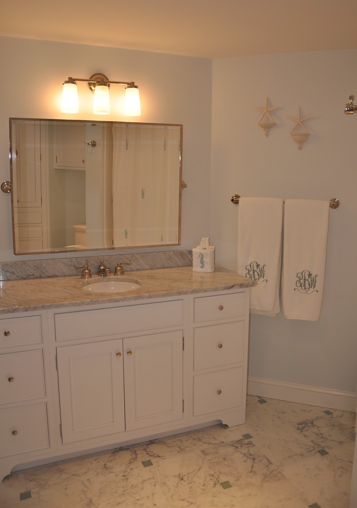 Photo of a coastal bathroom in Atlanta with a submerged sink, beaded cabinets, white cabinets, marble worktops, white tiles, stone tiles, blue walls and marble flooring.