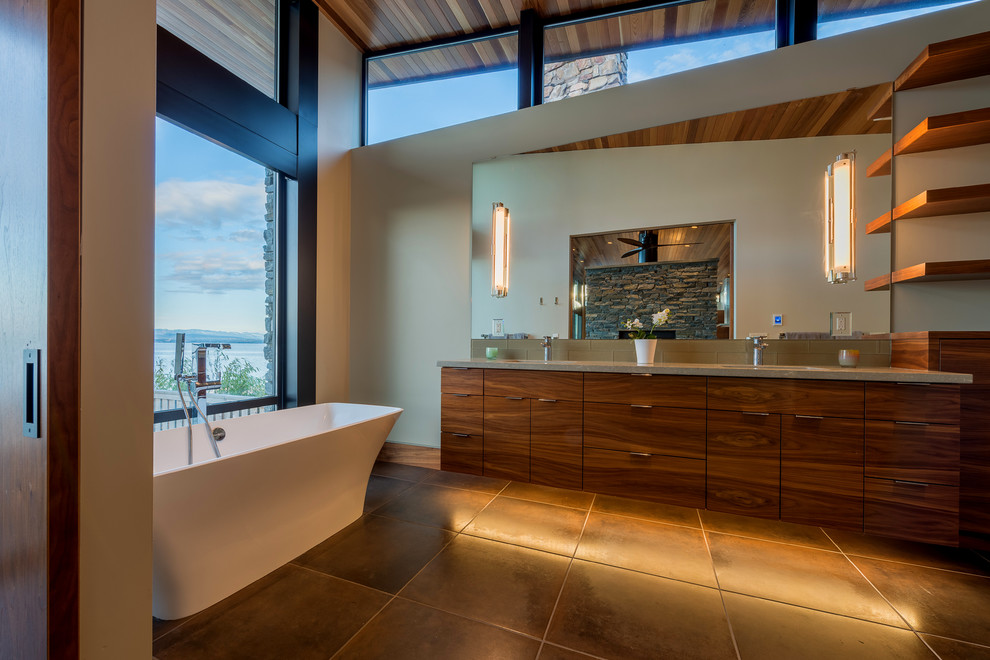 Bathroom - mid-sized modern master white tile and glass tile beige floor bathroom idea in Seattle with flat-panel cabinets, brown cabinets, a one-piece toilet, white walls, an undermount sink, solid surface countertops, a hinged shower door and gray countertops