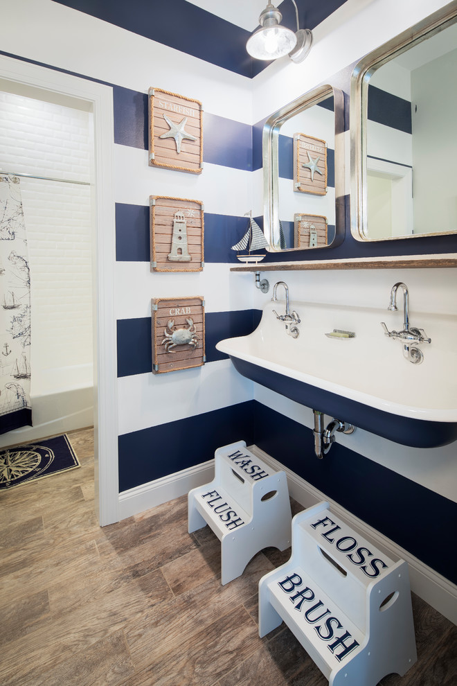 Example of a beach style kids' brown floor bathroom design in New York with a trough sink and multicolored walls
