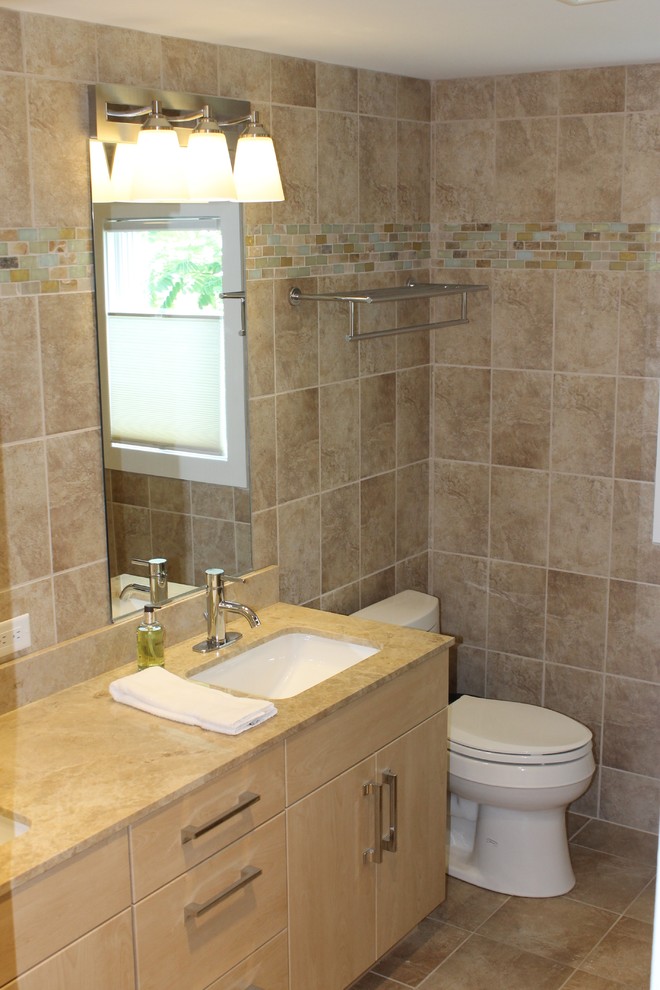 Bathroom - mid-sized coastal beige tile and ceramic tile ceramic tile bathroom idea in New York with an undermount sink, granite countertops, beige walls, light wood cabinets and flat-panel cabinets
