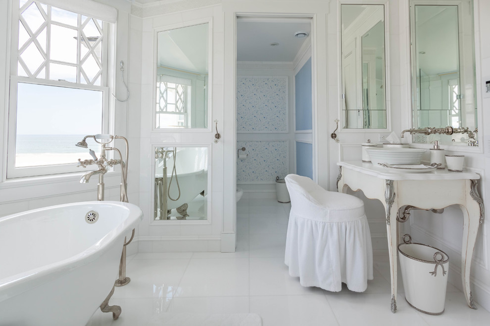 Example of a beach style white tile ceramic tile claw-foot bathtub design in Philadelphia with a vessel sink, white cabinets and white walls